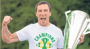  ??  ?? Celtic’s Scott Brown got his hands on the Premiershi­p trophy this week.