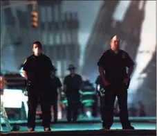  ?? Associated Press file photo ?? Police officers stand guard near the site of the World Trade Center in New York, in this Sept. 12, 2001, file photo.