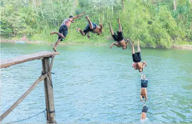  ??  ?? BALNEARIO MARAVILLA La tabla es el lugar preferido de los bañistas que disfrutan de hacer clavados sobre el río Humuya que pasa por el balneario. En la gráfica, el paso a paso del clavado de este bañista.