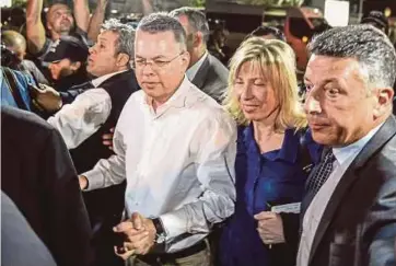  ?? AFP PIC ?? US pastor Andrew Brunson (third from right) arriving at Adnan Menderes airport in Izmir on Friday after being freed following a trial in a court in Aliaga in Izmir province.