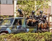  ?? LUDIVINE LANIEPCE / AP ?? Troops ride in a vehicle near the French Embassy in central Ouagadougo­u, Burkina Faso, Friday . Gunfire and explosions rocked Burkina Faso’s capital early Friday.