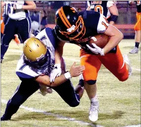  ?? Photo by Randy Moll ?? Berryville’s Luke Britt cuts short a run toward the goal line by Gravette senior Logan Rachel during play in Lion Stadium on Friday.