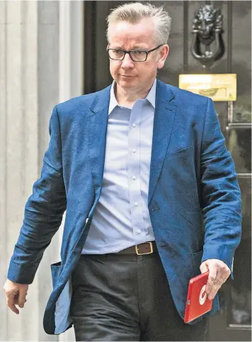  ??  ?? Michael Gove leaves No 10 yesterday after the Cabinet reshuffle. He said he was ‘flattered’ to be appointed Environmen­t Secretary