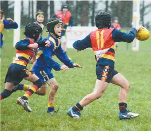  ??  ?? Left: Longwarry’s Lucas Earl gets his kick away as his Ellinbank opponent gives chase.
Longwarry won the match by 32 points; Photograph­s: Tom Elton