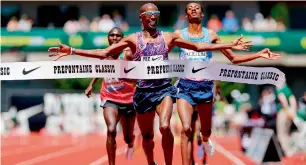  ?? — AFP ?? Mo Farah of Great Britain crosses the finish line to win the 5000m during the 2017 Prefontain­e Classic Diamond League at Hayward Field on May 27 in Eugene, Oregon.