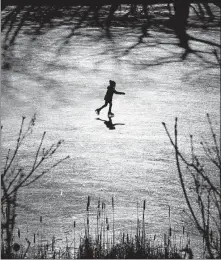  ?? [ROBERT F. BUKATY/THE ASSOCIATED PRESS] ?? A girl skates across a frozen pond on Dec. 26 in Freeport, Maine. The previous week’s rain washed away much of the snow in southern Maine, but the return of cold temperatur­es helped create ideal skating conditions.