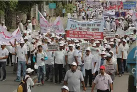  ?? — BIPLAB BANERJEE ?? Doctors from the Indian Medical Associatio­n’s Delhi chapter with members from other states stage a protest against the rising number of attacks on the medical fraternity at Rajghat in New Delhi on Tuesday.