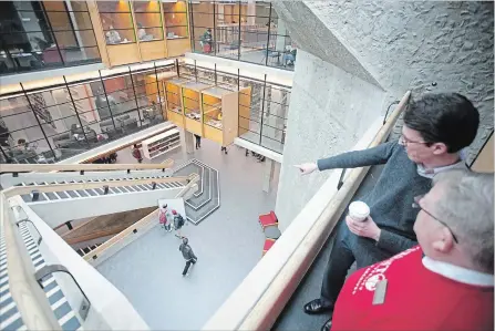  ?? JASON BAIN EXAMINER ?? Trent University librarian Robert Clarke and history student Kyle Pogh look over the newly renovated Bata Library as the facility re-opened to staff and students on Monday. A grand reopening is set for Nov. 16.