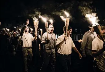  ?? EVELYN HOCKSTEIN/FOR THE WASHINGTON POST ?? Tiki Brand’s bamboo torches were used by white nationalis­t protesters during a march in Charlottes­ville, Va.