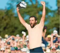  ?? ASHLEY LANDIS/AP ?? Scottie Scheffler raises his arms in celebratio­n after his win at the Masters on Sunday at Augusta National Golf Club in Augusta, Georgia.