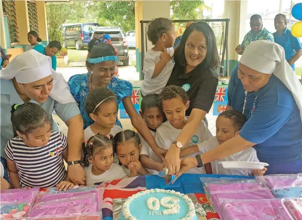  ?? Photo: Kelera Sovasiga. ?? Minister for Education, Heritage and Arts Rosy Akbar holds Adi Rosela, with Sister Kalolaine Tuineau (left), Sister Vutulongo Tuinayau (right), children and staff members of St Christophe­r’s Home in Naulu, Nasinu, on October 10, 2020.