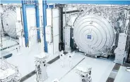  ?? Picture: ASML/Zeiss/ Handout via Reuters ?? Workers at Carl Zeiss ZMT outside giant vacuum chambers where optical systems for ASML’s new High NA EUV tool are tested in Oberkochen, Germany, in December.