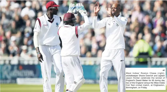  ?? AP ?? West Indies’ Roston Chase (right), wicketkeep­er Shane Dowrich and captain Jason Holder celebrate the wicket of England’s Dawid Malan for 65 during day two of the England versus the West Indies first Test cricket match, at Edgbaston, Birmingham, on...