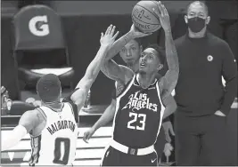  ?? MARK J. TERRILL — THE ASSOCIATED PRESS ?? Clippers guard Lou Williams, right, shoots past Kings guard Tyrese Haliburton during the first half Sunday at Staples Center in Los Angeles.