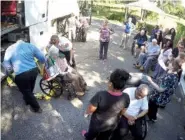  ?? THE ASSOCIATED PRESS ?? Staff members at Westwood Nursing and Rehabilita­tion Center in Fort Walton Beach, Fla., and firefighte­rs from Fort Walton Beach Fire Department load Hurricane Irma evacuees, who had stayed at Westwood since last Saturday, onto a bus Wednesday to head...