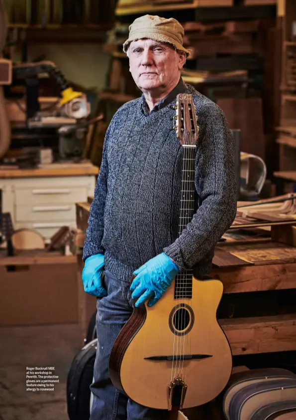  ??  ?? Roger Bucknall MBE at his workshop in Penrith. The protective gloves are a permanent feature owing to his allergy to rosewood