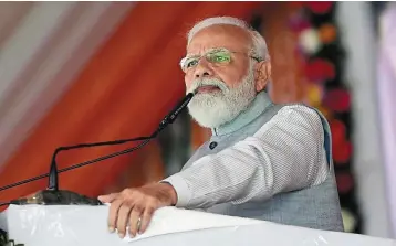  ?? — AFP ?? Tough call: A file picture showing Modi during an event in Uttar Pradesh. Stopping the food programme will not be an easy choice for him.