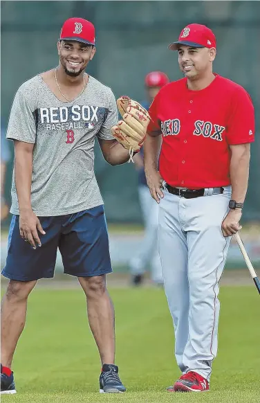  ?? STAFF PHOTO BY MATT STONE ?? EASY DOES IT: Xander Bogaerts and manager Alex Cora keep it light during yesterday’s spring training workout in Fort Myers.