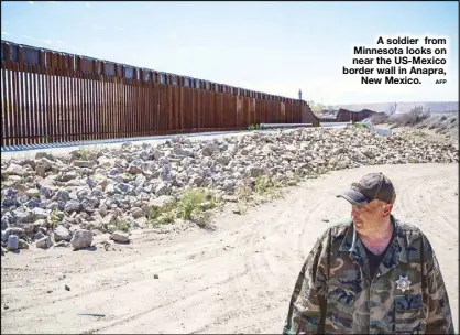  ??  ?? A soldier from Minnesota looks on near the US-Mexico border wall in Anapra, New Mexico.