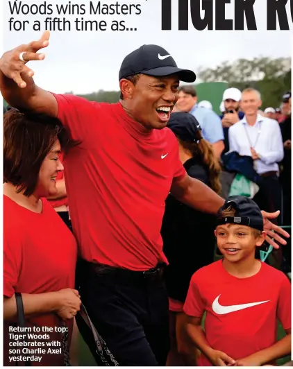  ??  ?? Return to the top: Tiger Woods celebrates with son Charlie Axel yesterday