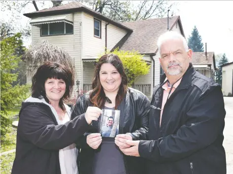  ?? DAN JANISSE ?? Christine Gaudet, left, and her husband Germain, with their daughter Rachelle, hold a photo of their son Julien, who died in 2011 at the age of 18. The family is shown in front of the home they donated to establish Julien's House, a registered charity that offers free bereavemen­t services.