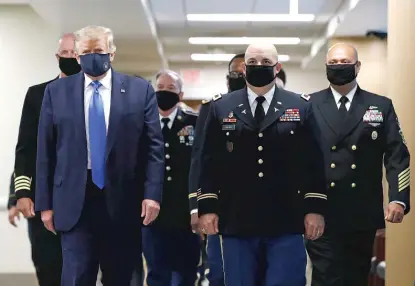  ?? AP FILE PHOTO ?? President Donald Trump refused to wear a mask for months when doing so would have saved American lives, Neil Steinberg writes. When he finally broke down, on July 11, he assembled a team of generals to stand behind him.