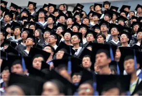  ?? CARLOS BARRÍA/REUTERS ?? A graduation ceremony in Shanghai, China. Students who wish to study in the US face heightened security checks