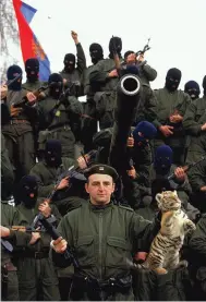  ?? ?? Clockwise from top: Golubović, on a motorcycle, wearing an Arkan’s Tigers uniform in Bijeljina on the day of the massacre; Golubović DJ’ing at a club in Belgrade; Arkan posing with his “Tigers” in Erdut, Croatia, in 1991.