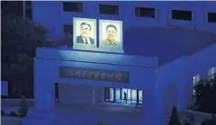  ??  ?? LEFT All public buildings in the country carry portraits of North Korea’s founder and his son, which are illuminate­d at night.