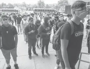  ?? MARKMIRKO/HARTFORD COURANT ?? New Britain High School students heading inside on the opening day of classes in September. It is the biggest school in New Britain, where day-to-day education funding will receive no new city money next year under a proposed budget.