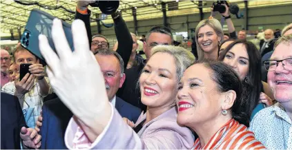  ?? PHOTO: REUTERS ?? All smiles . . . Sinn Fein deputy leader Michelle O’Neill and party leader Mary Louise McDonald take a selfie with supporters after Sinn Fein was voted as the largest party in Northern Ireland on Saturday.