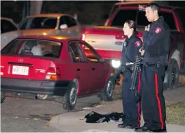  ?? Gavin Young/Calgary Herald ?? Police investigat­e a shooting near Western Canada High School on Thursday evening.