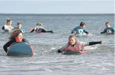  ?? ?? All smiles on the boards. Left: Martha Smith on the surf simulator.