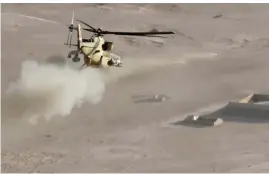  ??  ?? TALL ABTAH, Iraq: An Iraqi army Mi-35 helicopter shoots a missile at an Islamic State (IS) group target near this village near the city of Mosul on Friday. — AFP