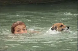  ?? PICTURE / PETER DE GRAAF ?? HISTORY: Hunter Kay joined jack russell Rosie in a dog swimming race at the 2016 Opua Community Regatta.