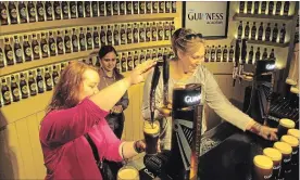  ?? SHAWN POGATCHNIK THE ASSOCIATED PRESS ?? The Guinness Storehouse in Dublin, Ireland. Visitors are given a choice between drinking their compliment­ary pint whether they pour it themselves or receive it from a bartender in the Storehouse’s rooftop pub.