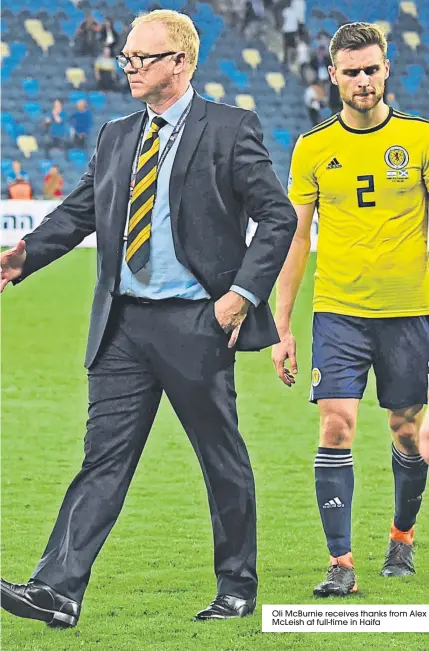  ??  ?? Oli Mcburnie receives thanks from Alex Mcleish at full-time in Haifa