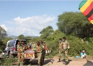  ?? —Picture:Tinai Nyadzayo ?? Members of the Zimbabwe National Army carrying the casket of liberation war hero, Cde John Gwitira, to his final resting place at Chimaniman­i District Heroes’ Acre on Sunday.