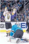  ?? JEFF CHIU/ASSOCIATED PRESS ?? Vegas Golden Knights’ right wing Reilly Smith, top, celebrates after scoring a goal as San Jose Sharks goalie Martin Jones reacts.