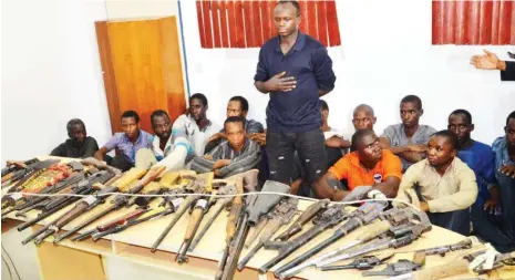  ?? Photo: Macjohn Akande ?? Suspects arrested during the crisis in Kafanchan, Kaduna State, being paraded with arms allegedly recovered from some of them at the Force Headquarte­rs in Abuja yesterday