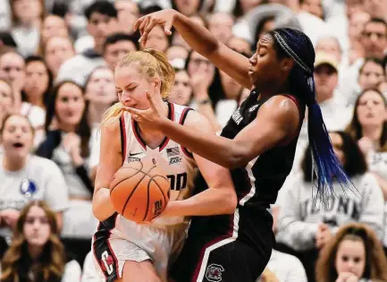  ?? Jessica Hill/Associated Press ?? South Carolina’s Aliyah Boston, right, pressures UConn’s Dorka Juhasz in the first half Sunday in Hartford.