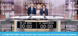  ?? ?? LA PLAINE-SAINT-DENIS, France: File photo shows French journalist­s and TV hosts Christophe Jakubyszyn (L) and Nathalie Saint-Cricq pose on the TV set installed in a studio, in La Plaine Saint Denis, outside Paris, on the eve of a face-to-face TV debate where French presidenti­al candidates will debate as part of their campaign for the second round. —AFP