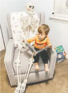  ?? ABIGAIL BRADY ?? Theo Brady takes Benny, life-sized skeleton, everywhere he goes. Theo even reads his favourite books to his companion.