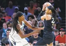  ?? STEVE MARCUS AP ?? New York Liberty’s Jonquel Jones, who had 16 points and 15 rebounds, guards Las Vegas Aces’ A’ja Wilson on Tuesday.