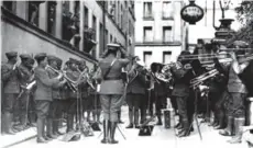  ??  ?? A picture taken in 1918 in Paris shows US 369th Infantry Regiment Jazz orchestra conducted by James Reese performing for war wounded in front of the Hotel de Tunis.