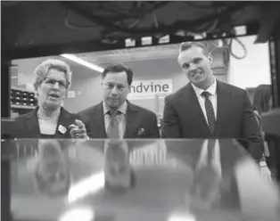  ?? RECORD STAFF FILE PHOTO ?? Premier Kathleen Wynne tours a Sandvine server room last year with MPP Brad Duguid, minister of economic developmen­t, employment and infrastruc­ture, centre, and David Miller, vice-president corporate finance at Sandvine Corporatio­n. An affiliate of...