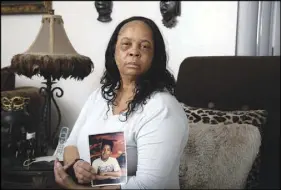  ?? STEVE MARCUS ?? Debra Simms holds a photo of her son, Xavier Crockett, in her Las Vegas apartment. Earlier this month, North Las Vegas Police said a man confessed to the 1996 slaying of Crockett, 15, and friend Jason Moore.