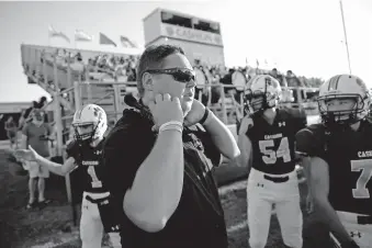  ?? [BRYAN TERRY/ THE OKLAHOMAN] ?? Cashion assistant coach Cale Cochran coaches on the sideline during a game against Perry earlier this season.