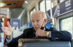  ?? Photos via AP ?? Democratic presidenti­al candidate former Vice President Joe Biden speaks with United Steelworke­rs Union President Thomas Conway and schoolteac­her Denny Flora of New Castle, Pa., aboard his train as it travels to Pittsburgh on Wednesday. Biden is on a train tour through Ohio and Pennsylvan­ia.