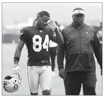  ?? AP/JEFF CHIU ?? Oakland Raiders’ Antonio Brown (left) walks off the field Tuesday after practice in Alameda, Calif.